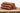 Corderro Premium chicken meat sticks with mild heat, showing four cooked chicken sticks on a plate, ready to serve.